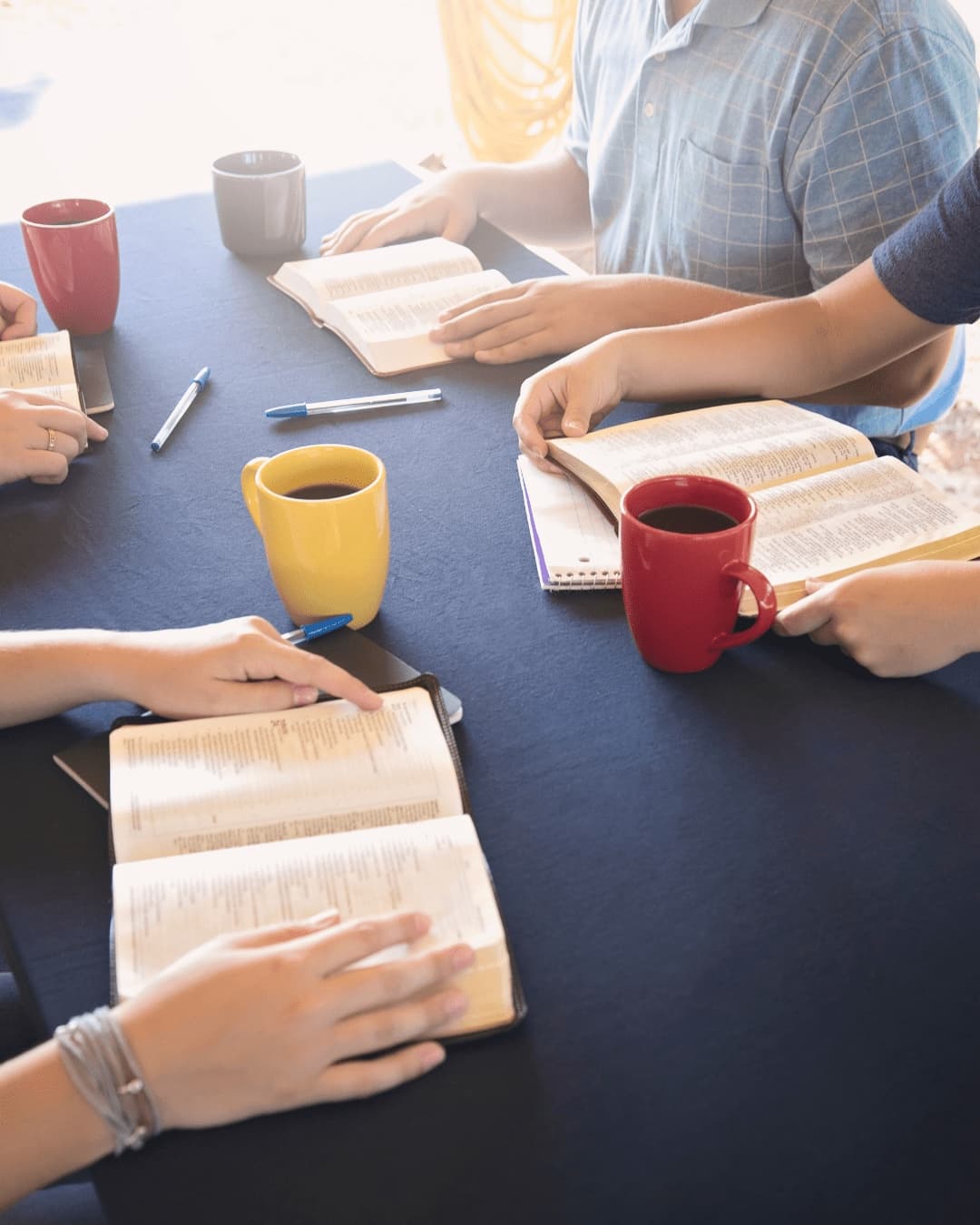 Open Bibles gathered around a study table