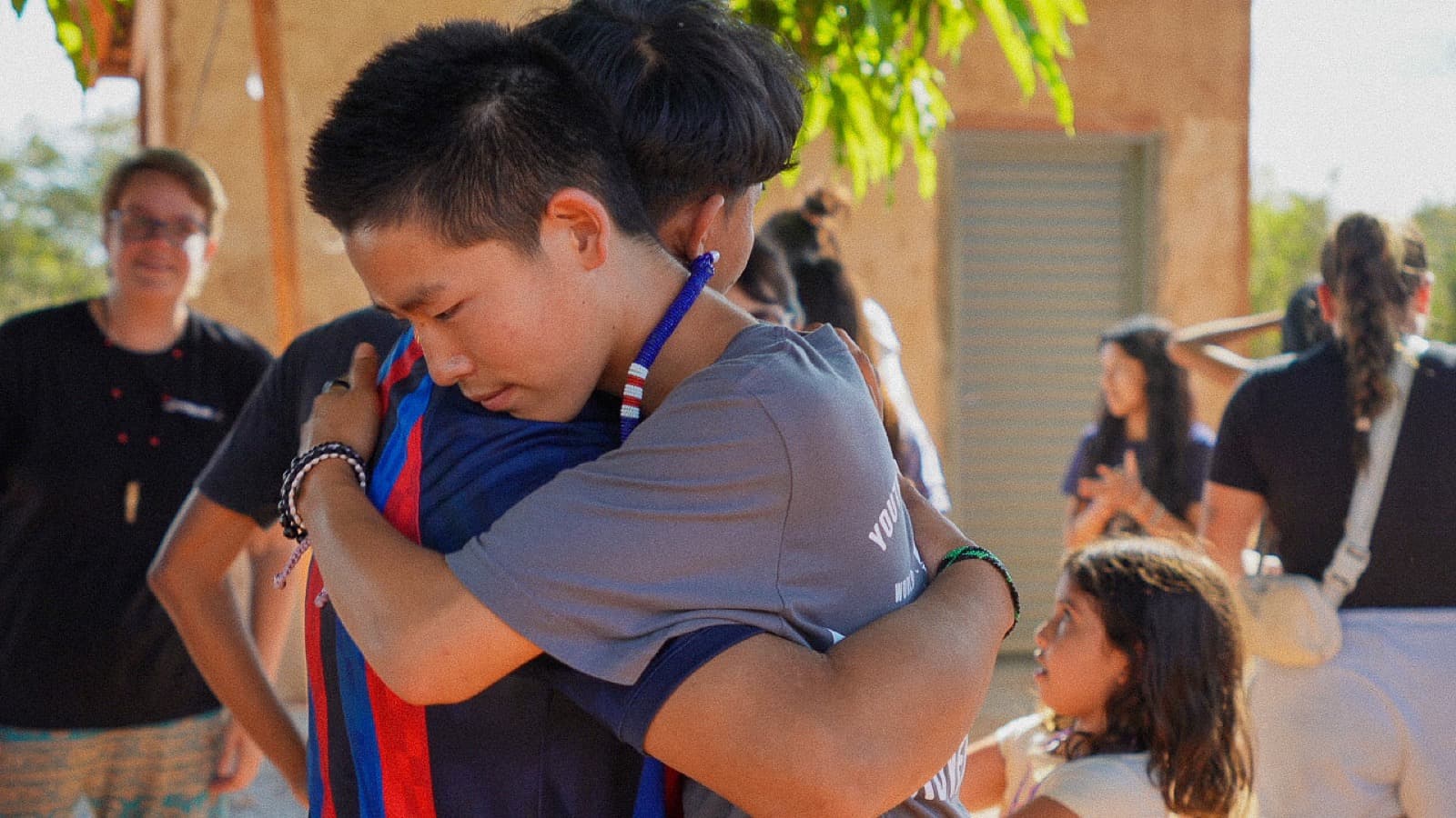 Two Mission Adventures participants sharing an encouraging embrace